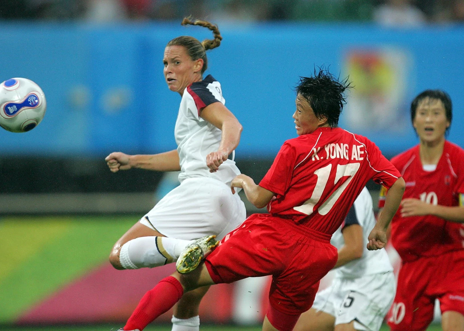 Christie Rampone of the USA moves the ball away from Kim Yong Ae of Korea.
