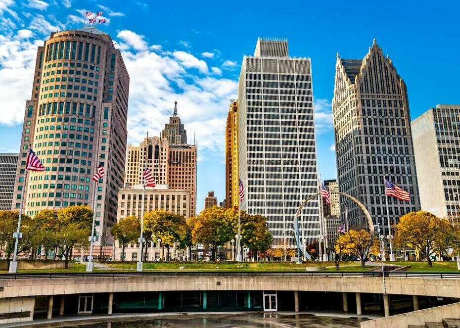 Tall buildings with American flags in front in Detroit, Michigan.