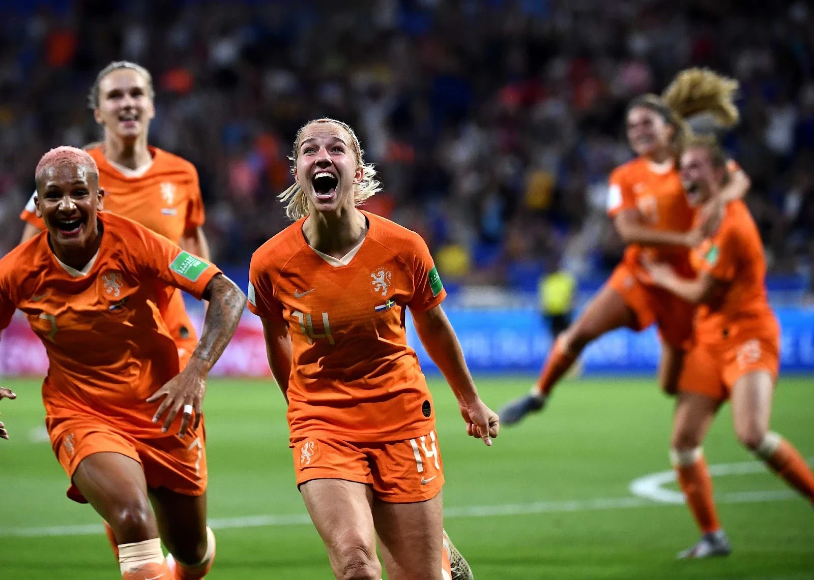 Netherlands' midfielder Jackie Groenen is congratulated by teammates after scoring a goal during the France 2019 Women's World Cup semifinal.